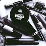 Elegant monochrome flatlay showcasing a collection of beauty products and cosmetics.