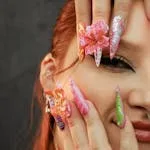 Vibrant and intricate nail art on a woman's hands, showcasing creativity and style.